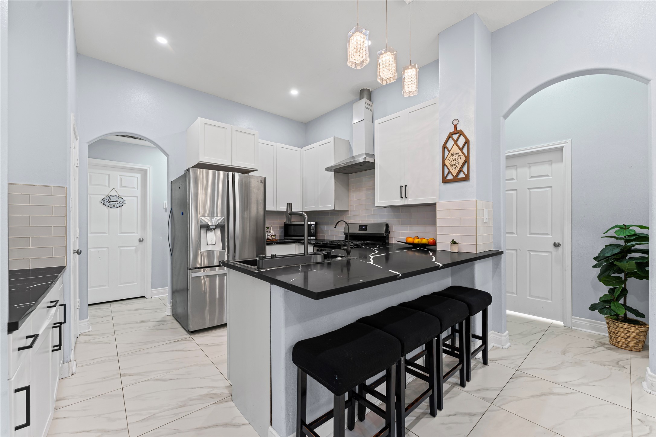 822 Green Pines Forest Houston, TX 77067 - Photo 5 of 18 a kitchen with stainless steel appliances kitchen island granite countertop a refrigerator a sink dishwasher a dining table and chairs with wooden floor