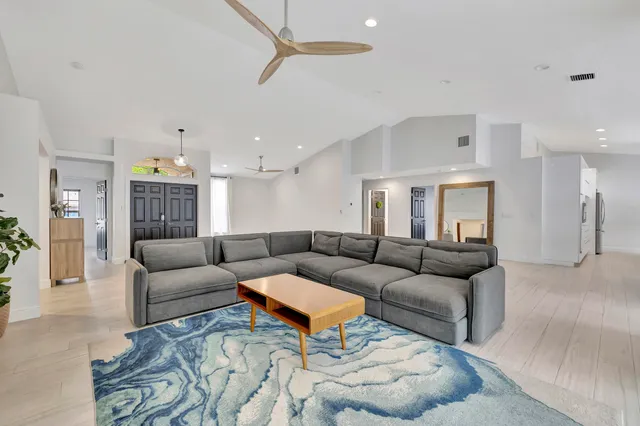 a living room with furniture and kitchen view