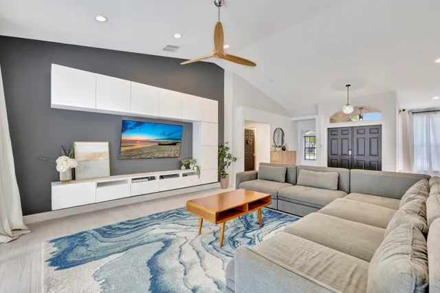 a living room with furniture and a flat screen tv