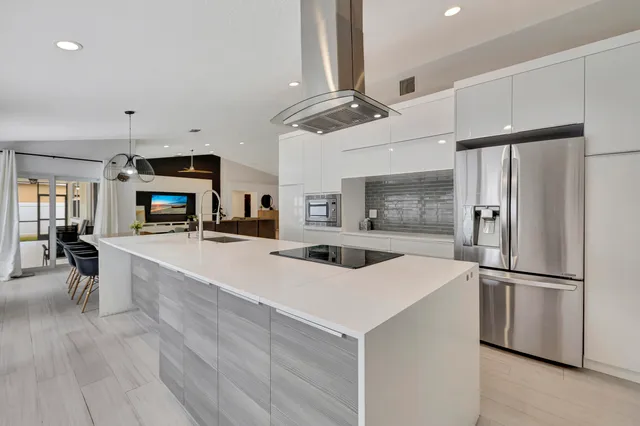 a view of a kitchen with a sink and refrigerator