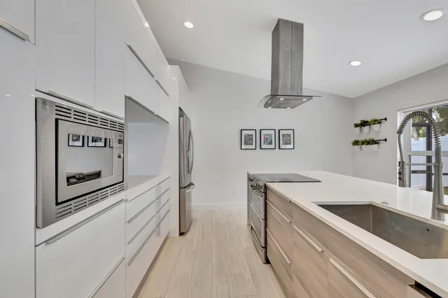 a kitchen with a sink and chandelier