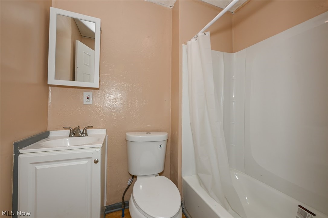 868 North Main Street Akron, OH 44310 - Photo 26 of 30 Full bathroom featuring vanity, a textured wall, and shower / bath combo with shower curtain