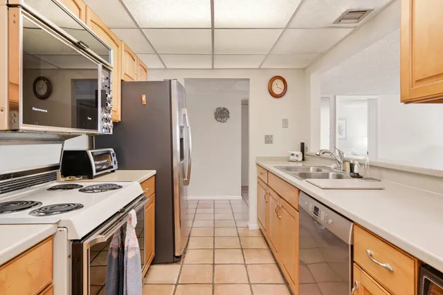 a large kitchen with a stove and a refrigerator