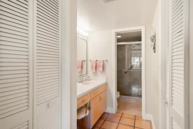 a spacious bathroom with a sink a mirror and a shower