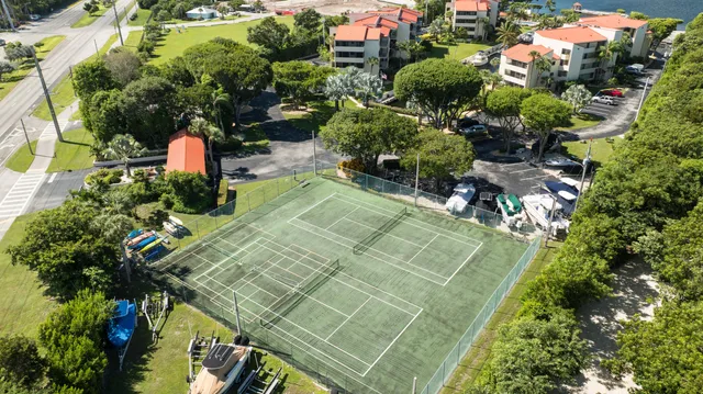 a view of a swimming pool with a table and chairs under an umbrella
