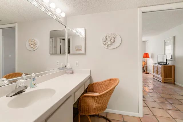 a hallway with a sink and a mirror