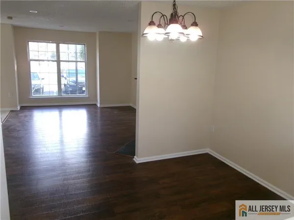 a view of a room with wooden floor and windows