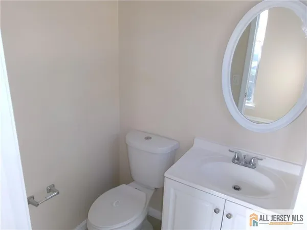 a white toilet sitting next to a bathroom sink