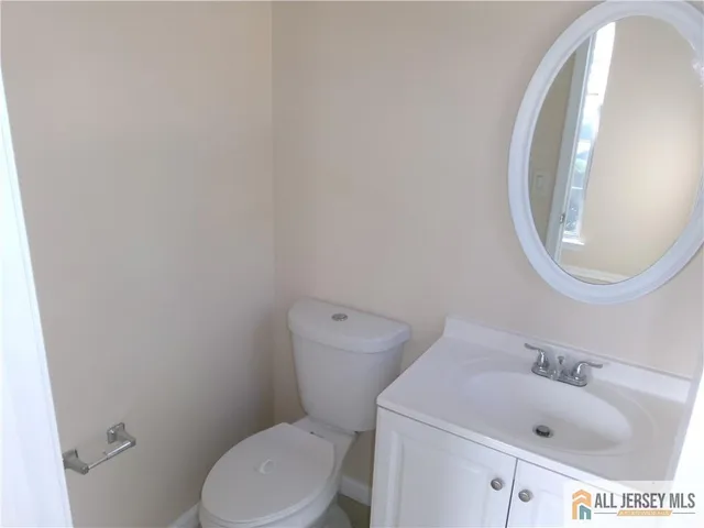 a white toilet sitting next to a bathroom sink
