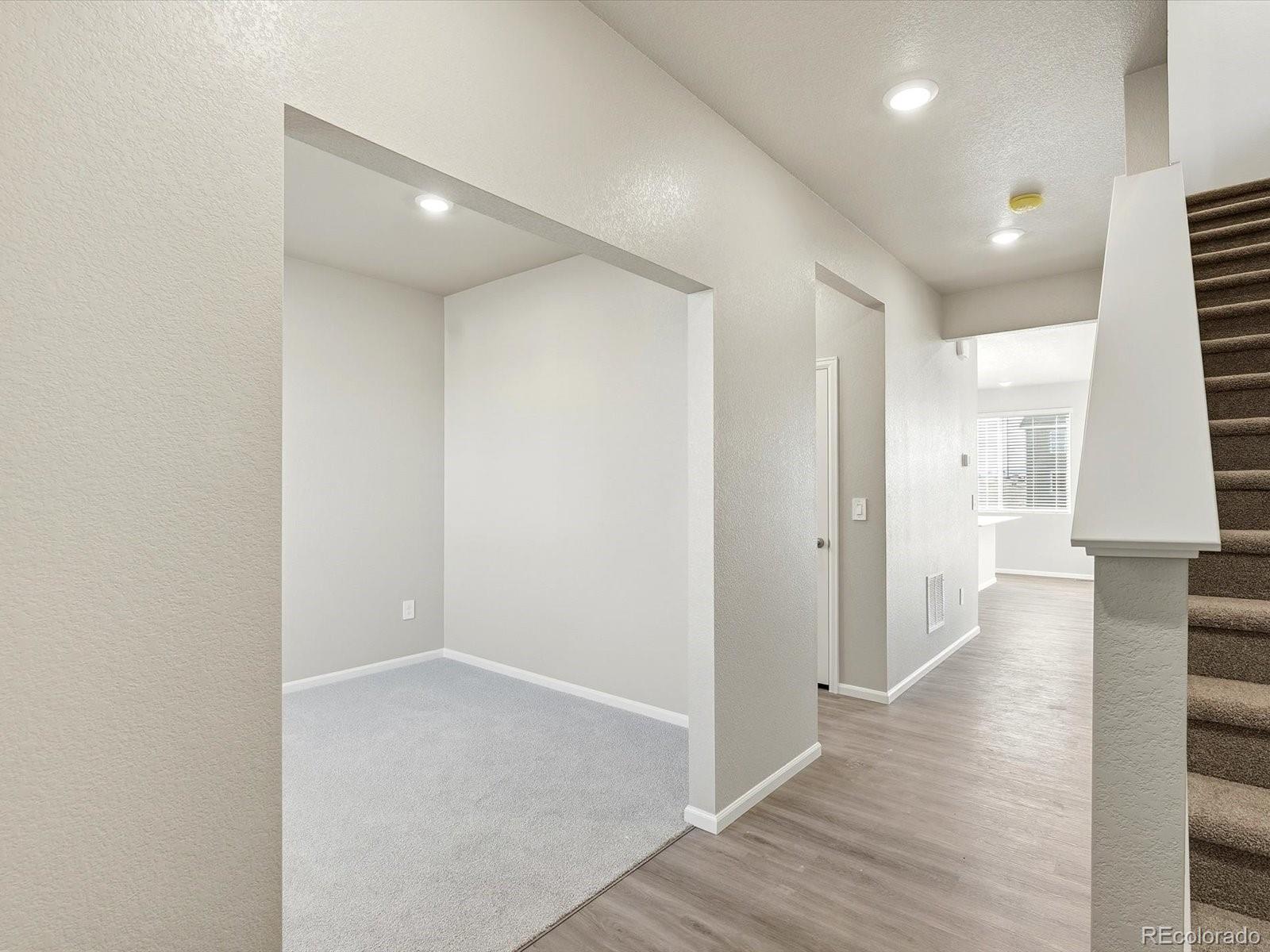 7317 West 27th St Road Greeley, CO 80634 - Photo 2 of 28 a view of a hallway with wooden floor