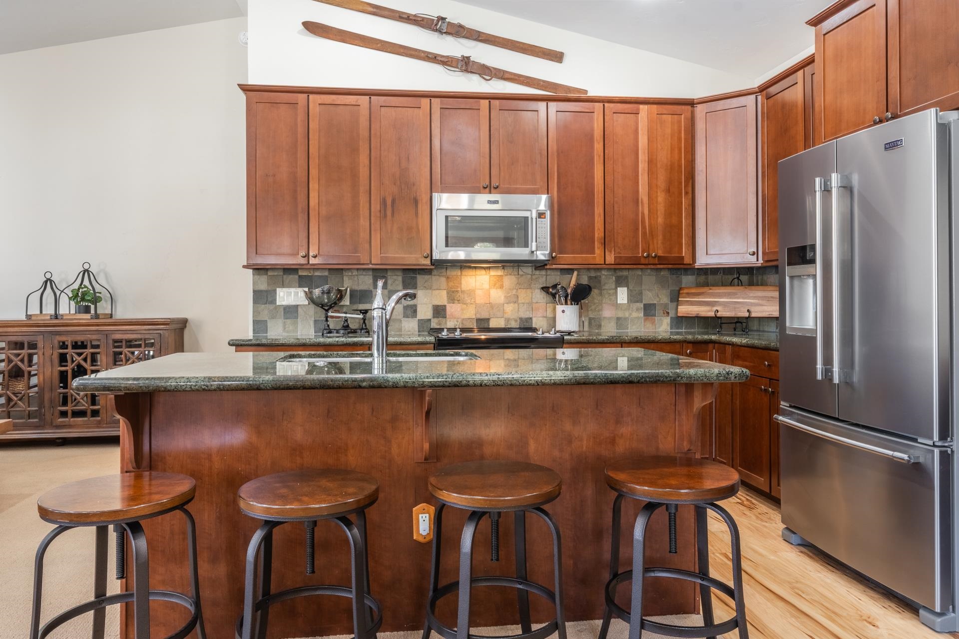 125 Davison Road, Unit 1 Mammoth Lakes, CA 93546 - Photo 9 of 46 a kitchen with a table chairs refrigerator and cabinets