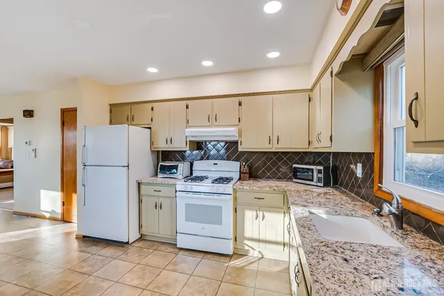 a kitchen with a stove sink and refrigerator