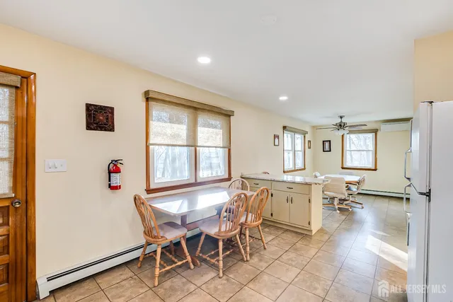 a view of a dining room with furniture and a window