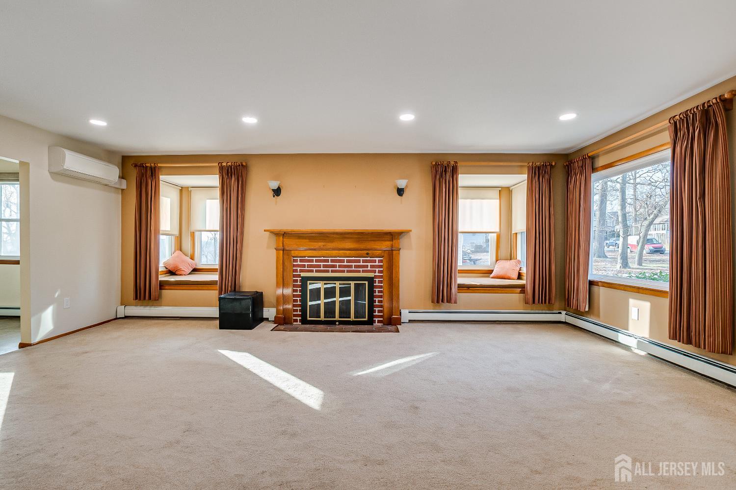 92 Coleman Street Edison, NJ 08817 - Photo 14 of 32 a view of an empty room with a fireplace and a window