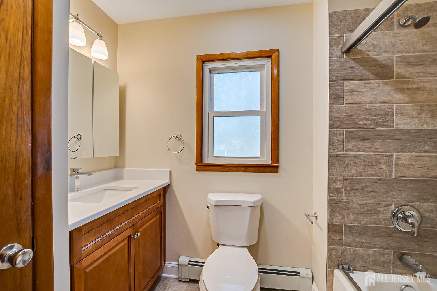 92 Coleman Street Edison, NJ 08817 - Photo 15 of 32 a bathroom with a sink a toilet and mirror