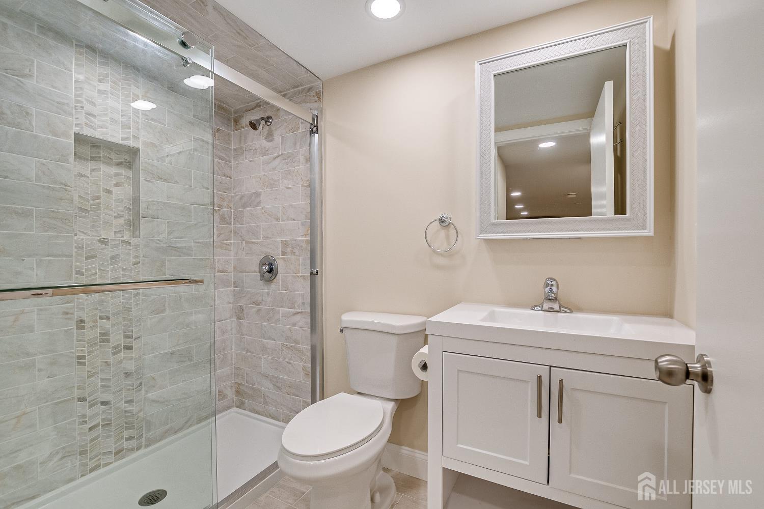 92 Coleman Street Edison, NJ 08817 - Photo 30 of 32 a bathroom with a sink a toilet and shower