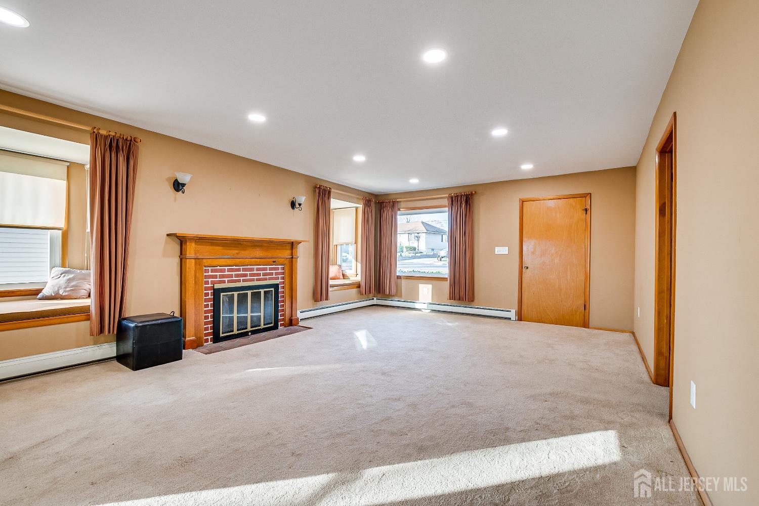 92 Coleman Street Edison, NJ 08817 - Photo 6 of 32 a view of an empty room with a fireplace and a window