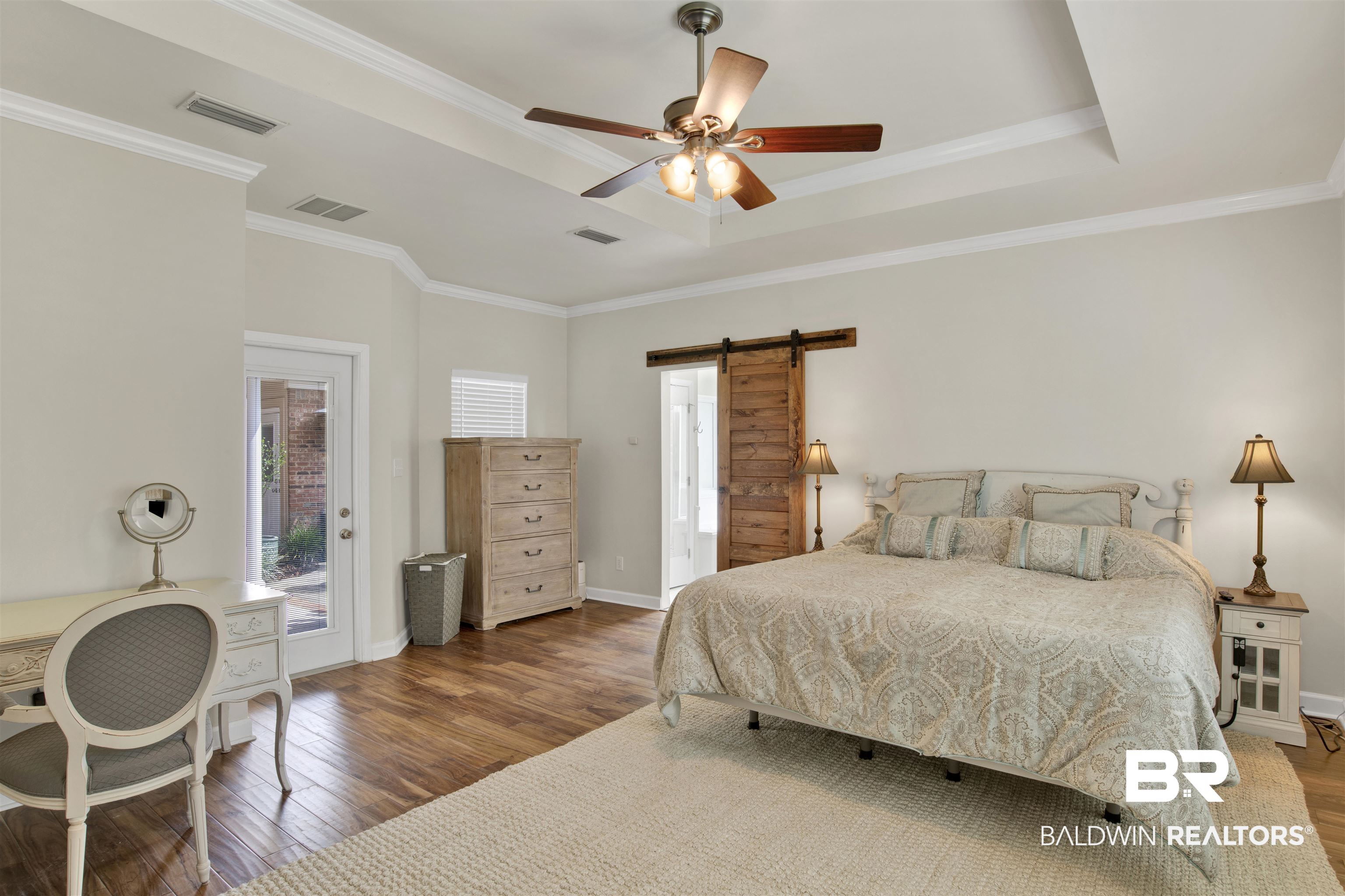 638 Southern Way Daphne, AL 36527 - Photo 14 of 26 Bedroom with ornamental molding, dark hardwood / wood-style floors, a raised ceiling, and a barn door