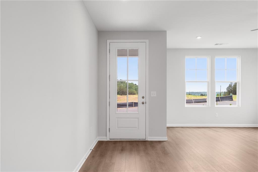 115 Pk Rdg Circle Cartersville, GA 30120 - Photo 3 of 25 an empty room with wooden floor and windows