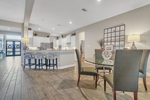 1541 North Blue Bonnet Lane Angleton, TX 77515 - Photo 12 of 28 a view of a dining room with furniture and wooden floor