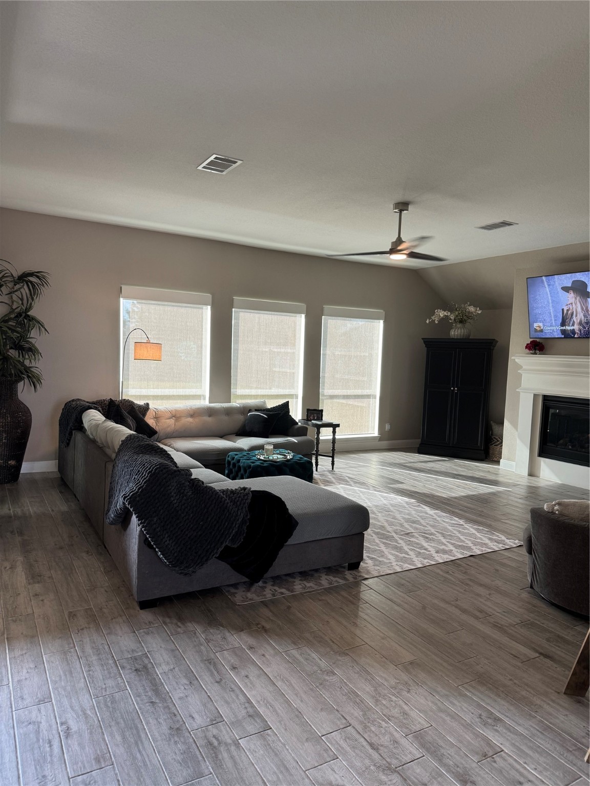 1541 North Blue Bonnet Lane Angleton, TX 77515 - Photo 14 of 28 a spacious bedroom with a bed and wooden floor