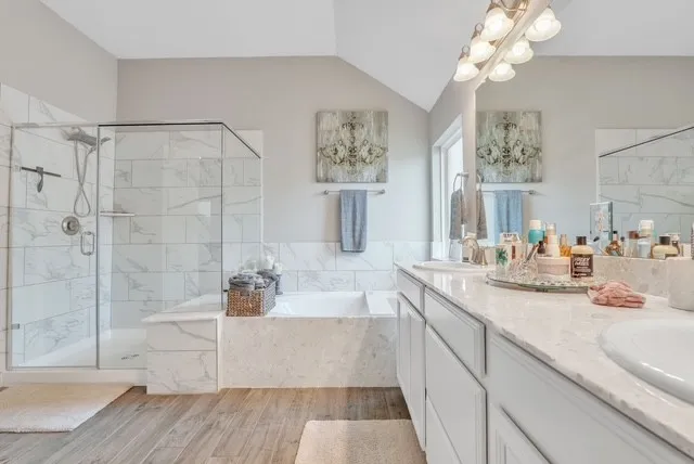 a spacious bathroom with a tub a sink and mirrors