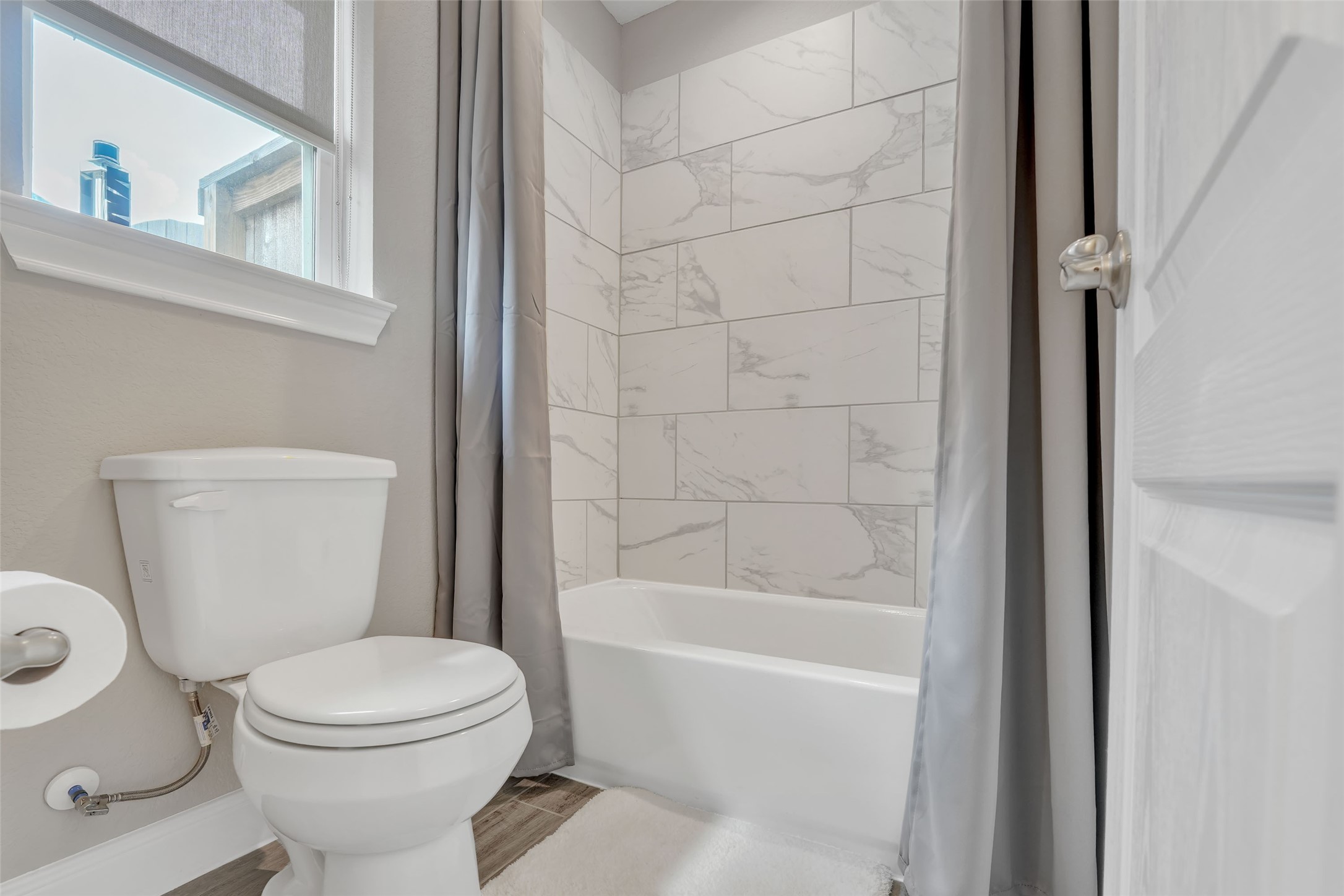1541 North Blue Bonnet Lane Angleton, TX 77515 - Photo 23 of 28 a white toilet sitting next to a bath tub