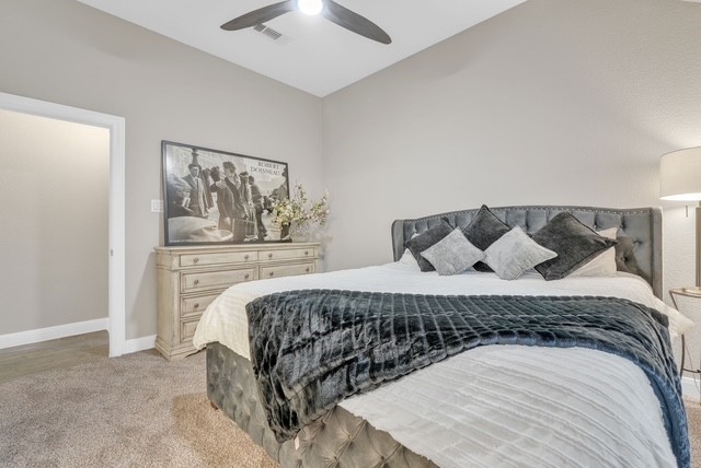 1541 North Blue Bonnet Lane Angleton, TX 77515 - Photo 24 of 28 a bedroom with a bed and lamp