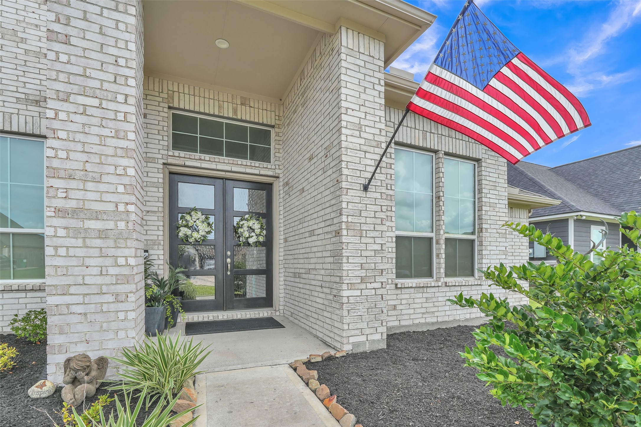 1541 North Blue Bonnet Lane Angleton, TX 77515 - Photo 27 of 28 a front view of a house with a yard