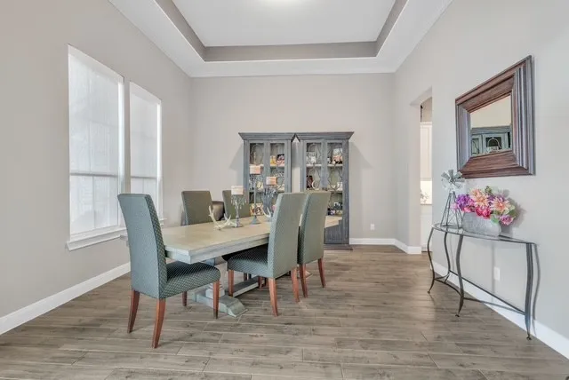 a view of a dining room with furniture wooden floor and a window