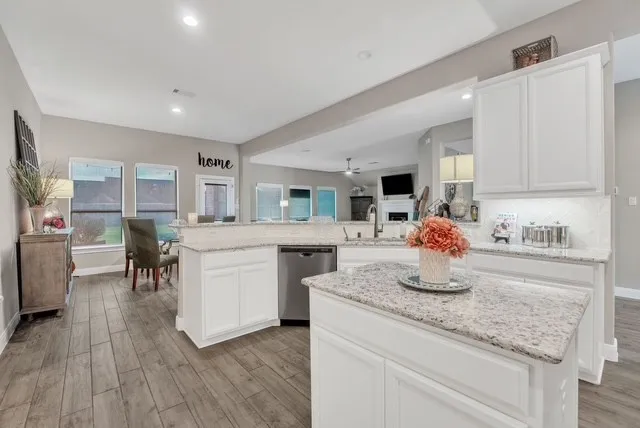 a kitchen with sink cabinets and wooden floor