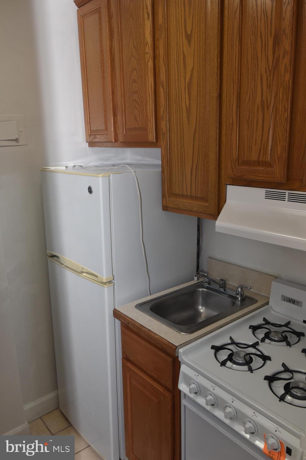 1011 Arlington Boulevard, Unit 710 Arlington, VA 22209 - Photo 6 of 10 a kitchen with a stove and a refrigerator