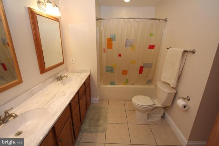 6030 Detrick Road Mount Airy, MD 21771 - Photo 3 of 30 a bathroom with a granite countertop sink toilet and shower