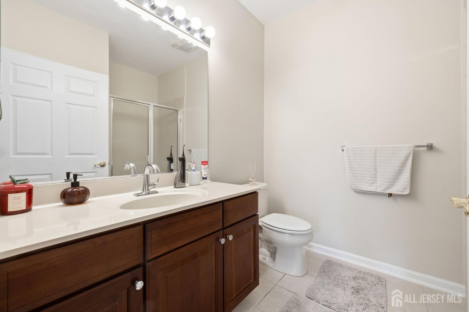 540 Cranbury Road, Unit 107 East Brunswick, NJ 08816 - Photo 11 of 20 a bathroom with a sink and a mirror