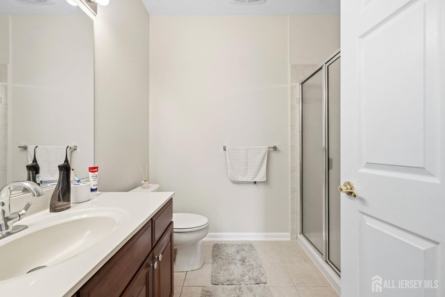 540 Cranbury Road, Unit 107 East Brunswick, NJ 08816 - Photo 12 of 20 a bathroom with a sink a toilet and shower