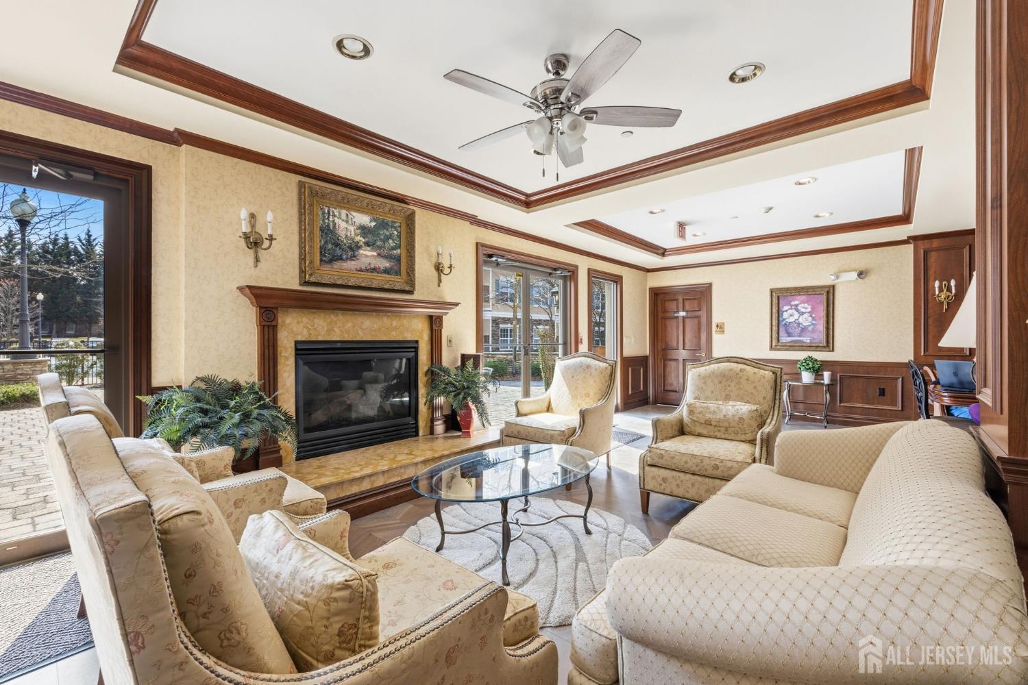 540 Cranbury Road, Unit 107 East Brunswick, NJ 08816 - Photo 20 of 20 a living room with furniture a fireplace and a large window