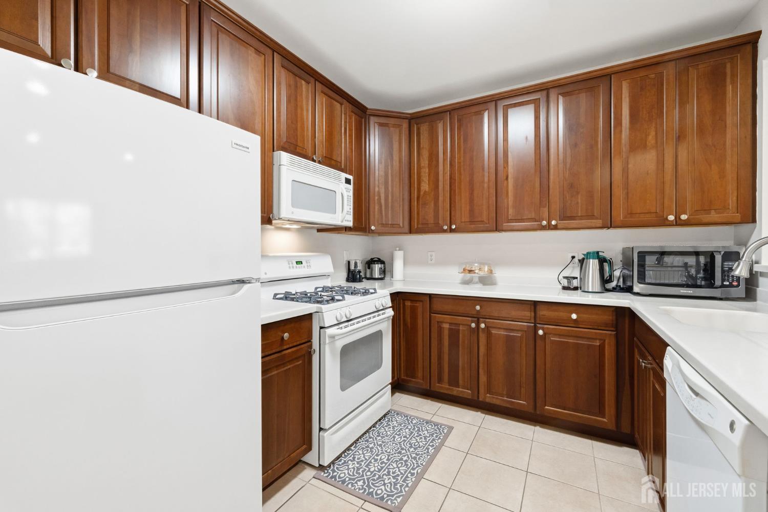 540 Cranbury Road, Unit 107 East Brunswick, NJ 08816 - Photo 2 of 20 a kitchen with stainless steel appliances granite countertop a stove a sink and a refrigerator