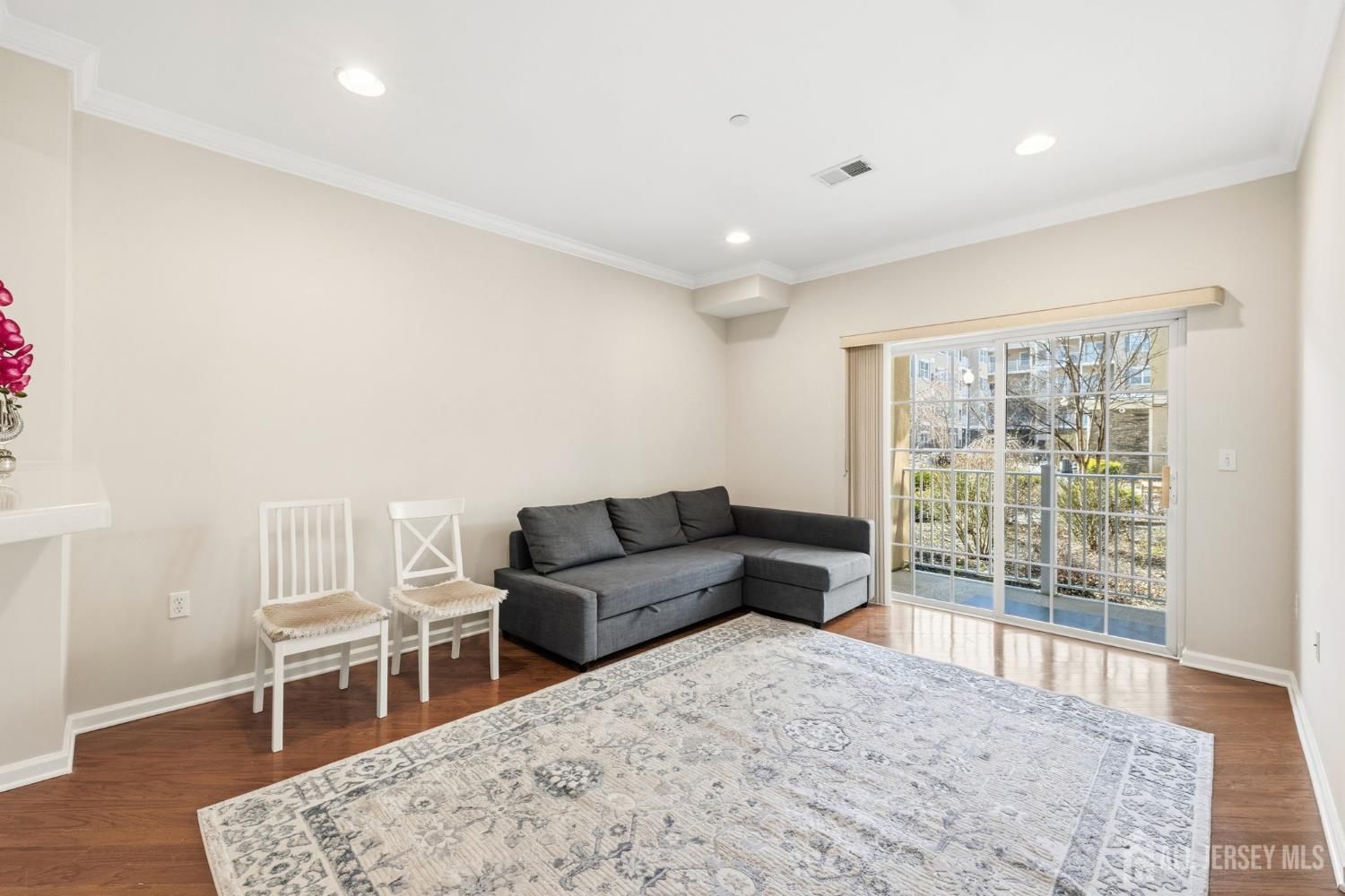 540 Cranbury Road, Unit 107 East Brunswick, NJ 08816 - Photo 3 of 20 a living room with furniture a wooden floor and next to window
