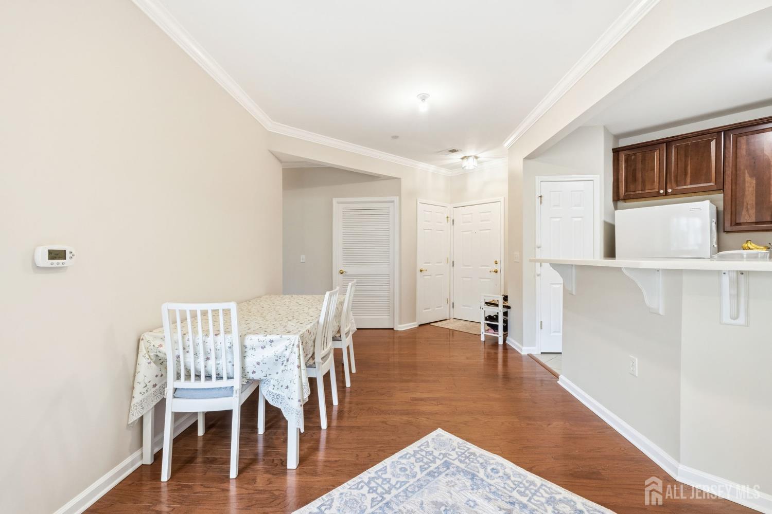 540 Cranbury Road, Unit 107 East Brunswick, NJ 08816 - Photo 6 of 20 a view of a dining room with furniture and wooden floor