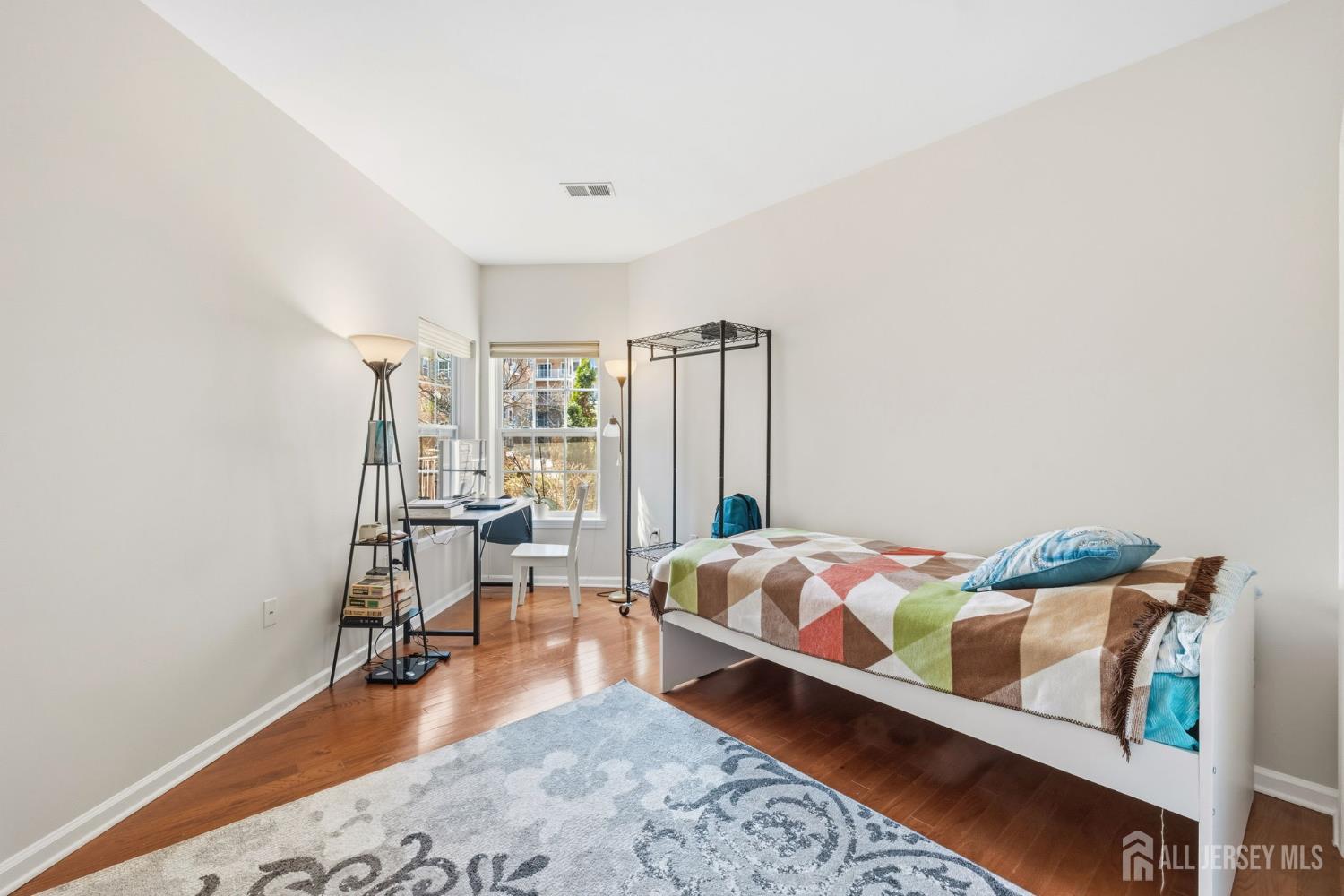 540 Cranbury Road, Unit 107 East Brunswick, NJ 08816 - Photo 7 of 20 a bedroom with a bed and wooden floor
