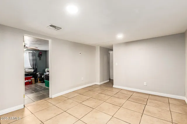 a bedroom with a bed a table and chair