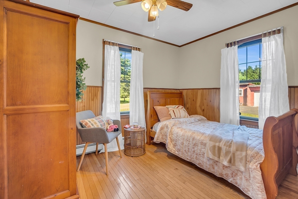 4287 South Athol Road Athol, MA 01331 - Photo 34 of 42 a bedroom with a bed and a chandelier fan