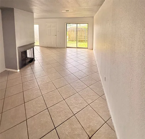 a view of a livingroom with an empty space and a window