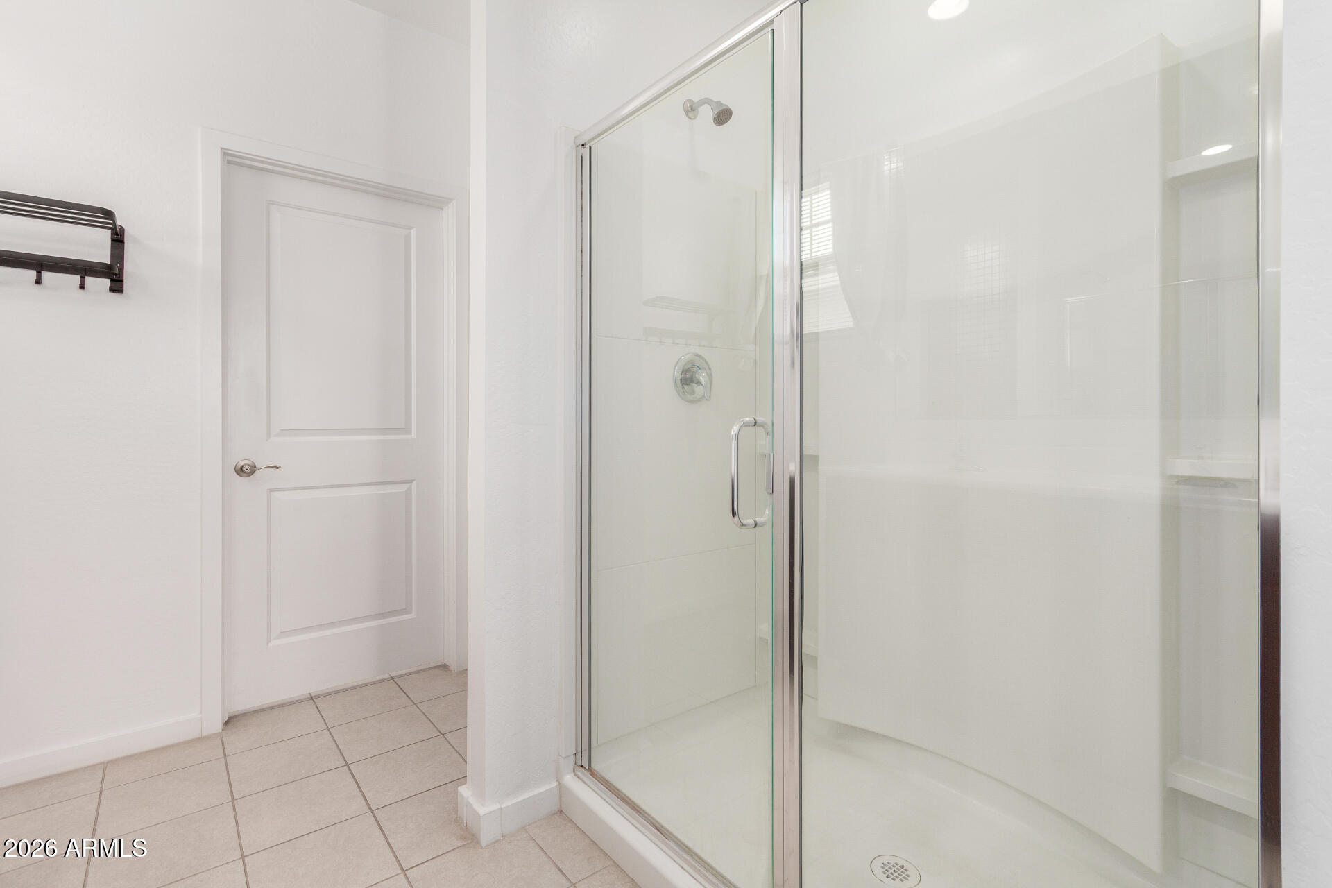 10734 West Bloch Road Tolleson, AZ 85353 - Photo 11 of 20 a bathroom with a glass shower door