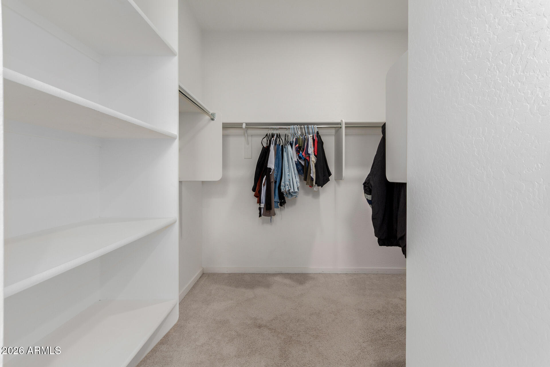 10734 West Bloch Road Tolleson, AZ 85353 - Photo 12 of 20 a view of walk in closet with clothes