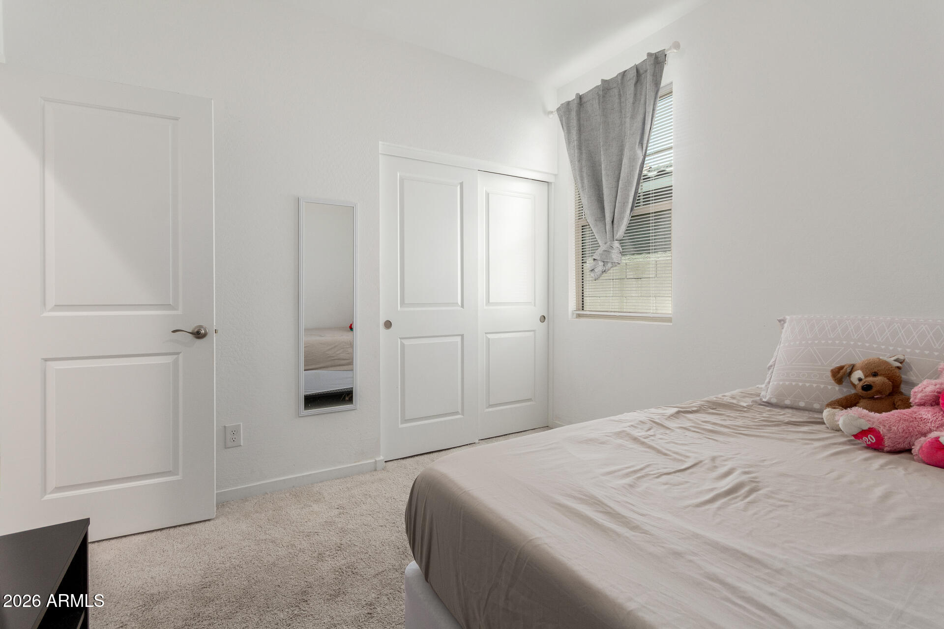 10734 West Bloch Road Tolleson, AZ 85353 - Photo 14 of 20 a bedroom with a bed and a window