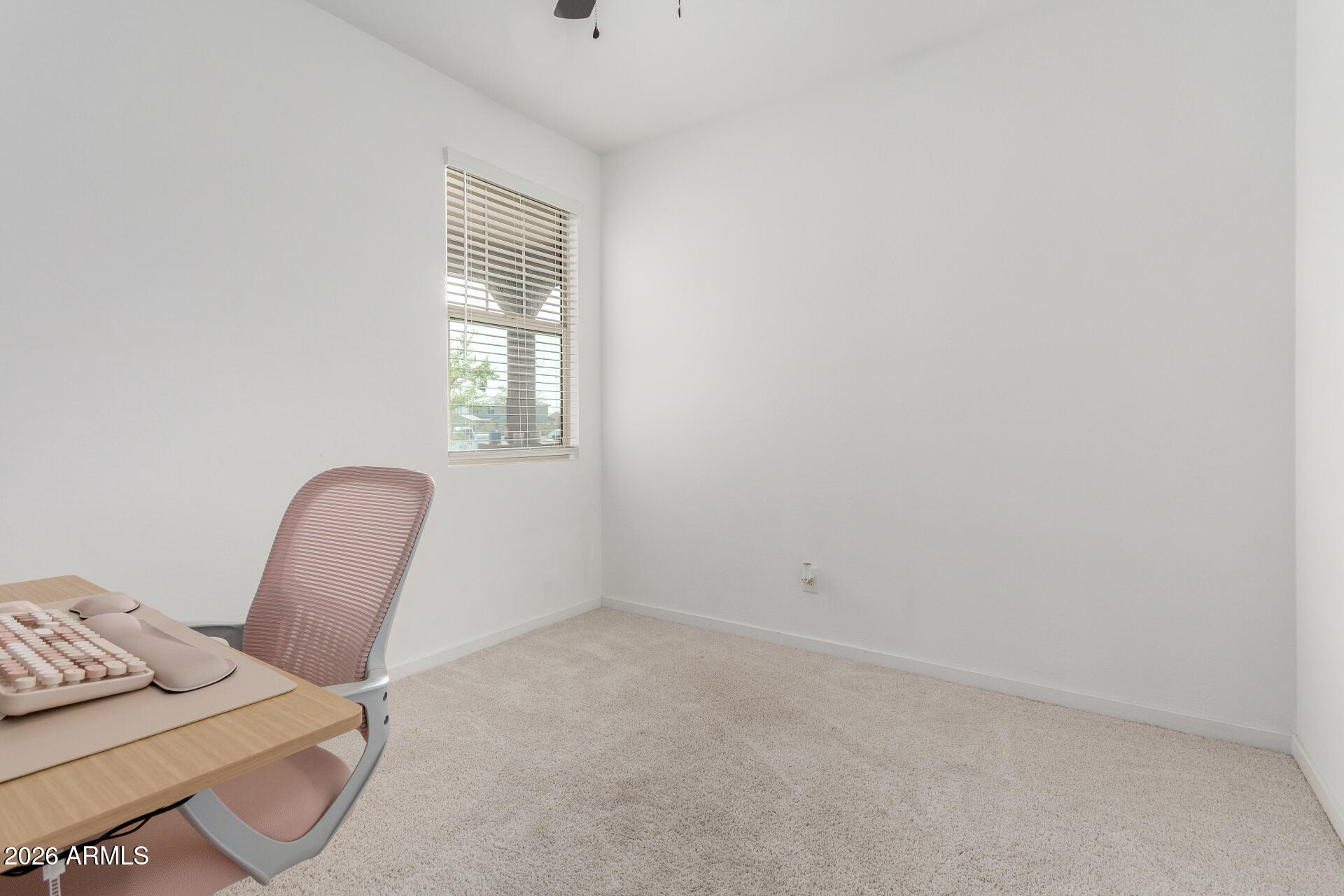 10734 West Bloch Road Tolleson, AZ 85353 - Photo 15 of 20 a room with a chair and a window
