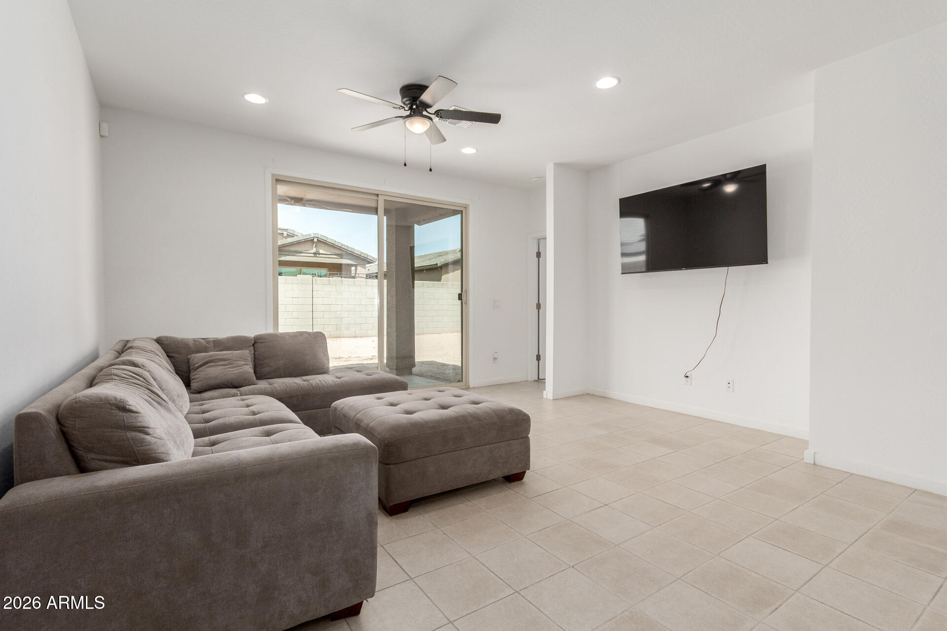 10734 West Bloch Road Tolleson, AZ 85353 - Photo 4 of 20 a living room with furniture and a flat screen tv