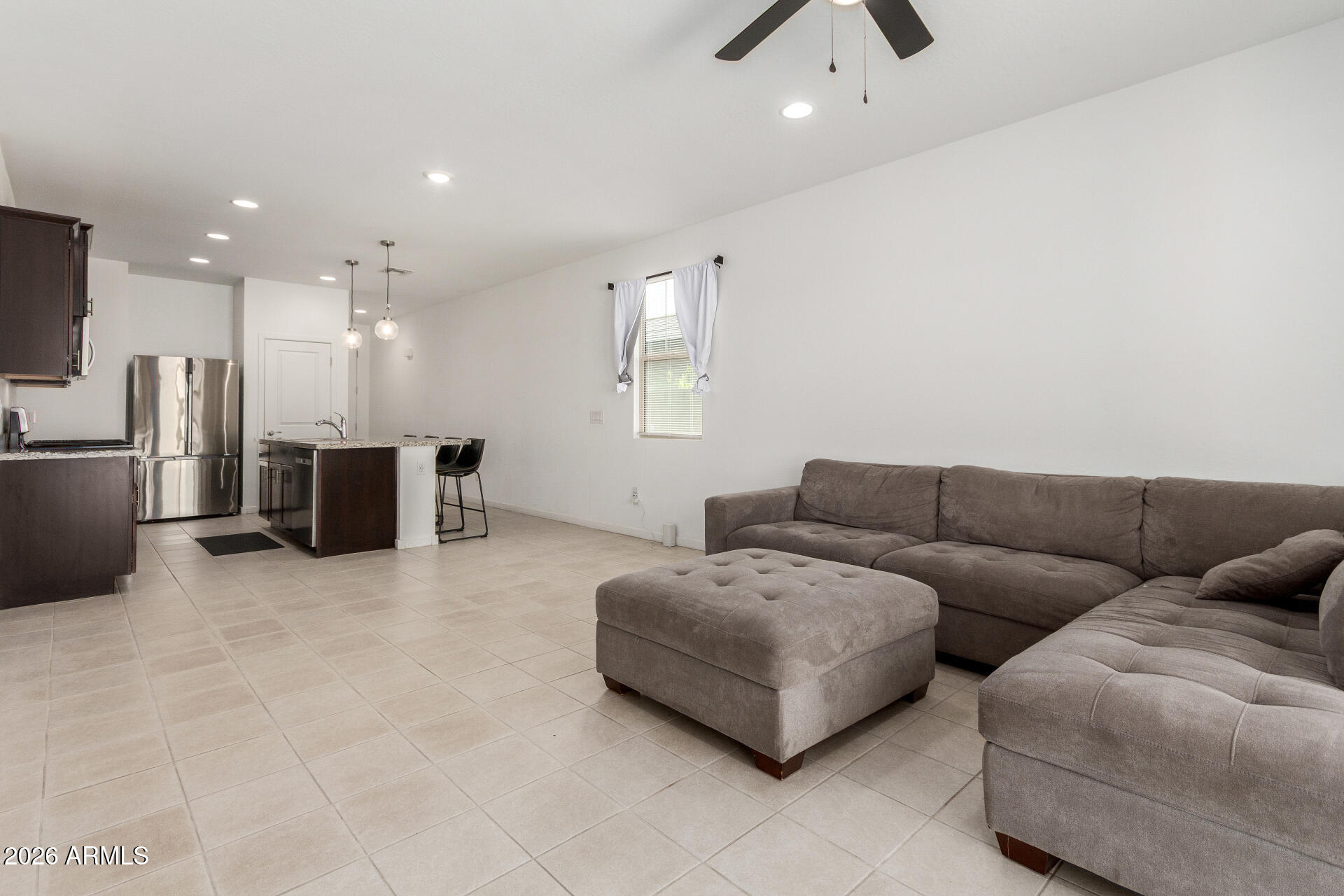10734 West Bloch Road Tolleson, AZ 85353 - Photo 5 of 20 a living room with furniture and a flat screen tv