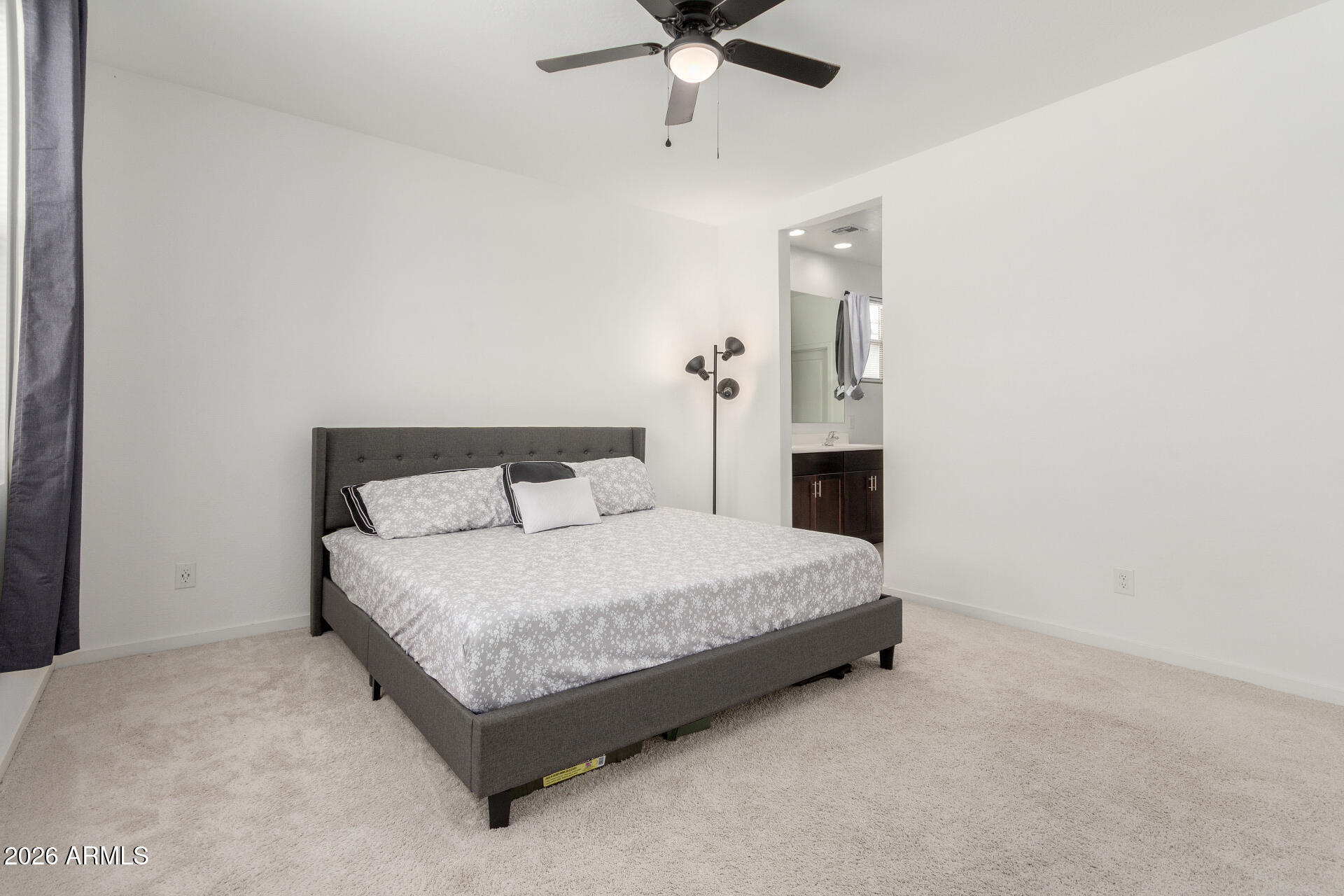 10734 West Bloch Road Tolleson, AZ 85353 - Photo 8 of 20 a spacious bedroom with a bed and window